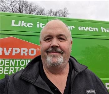 SERVPRO employee in front of green background